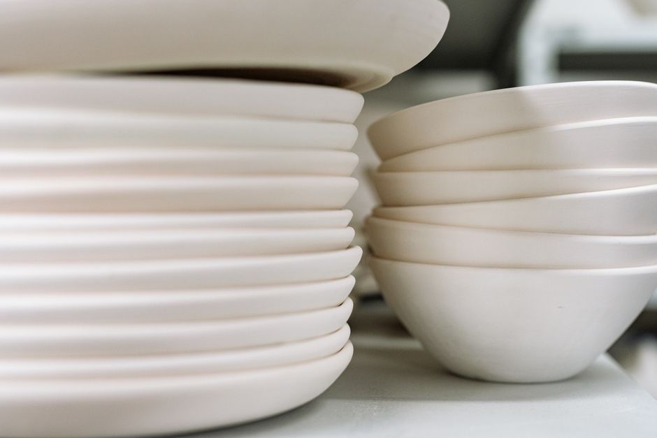 Close-up of stacked ceramic bowls and plates showcasing fine craftsmanship.